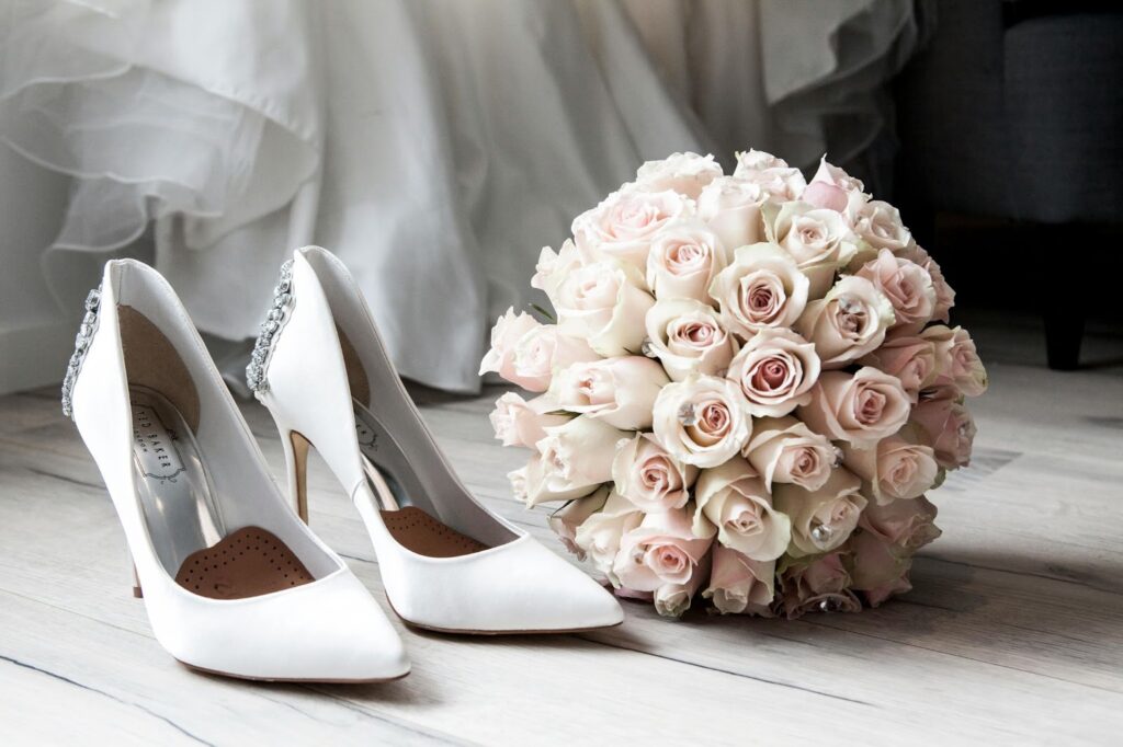 A brides shoes and bouquet