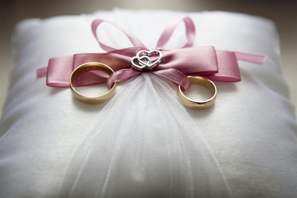Wedding rings tied with ribbon on a pillow