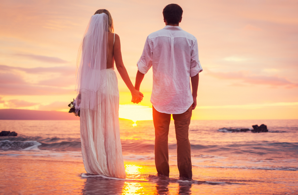 wedded couple on beach during a sunset